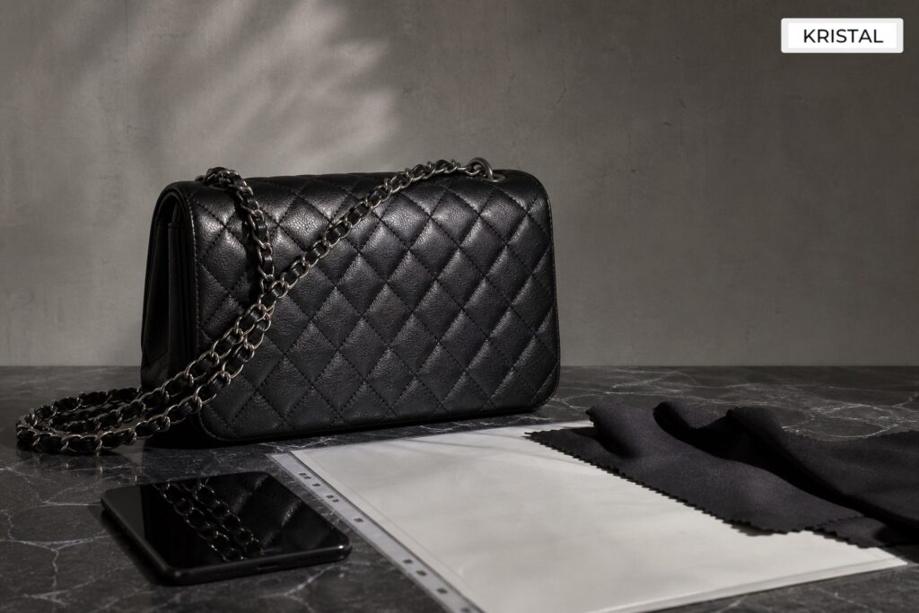 Photorealistic plain black quilted luxury handbag with blank appraisal documents for a Malaysia Chanel valuation guide