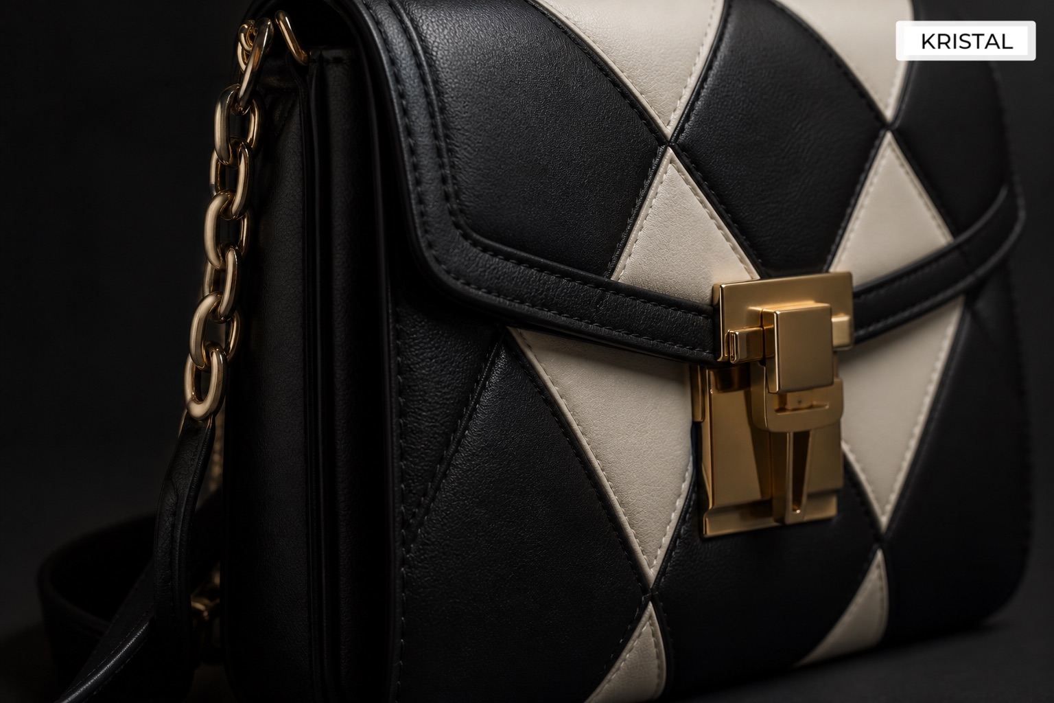 Close-up of black and ivory geometric quilted leather and muted gold clasp