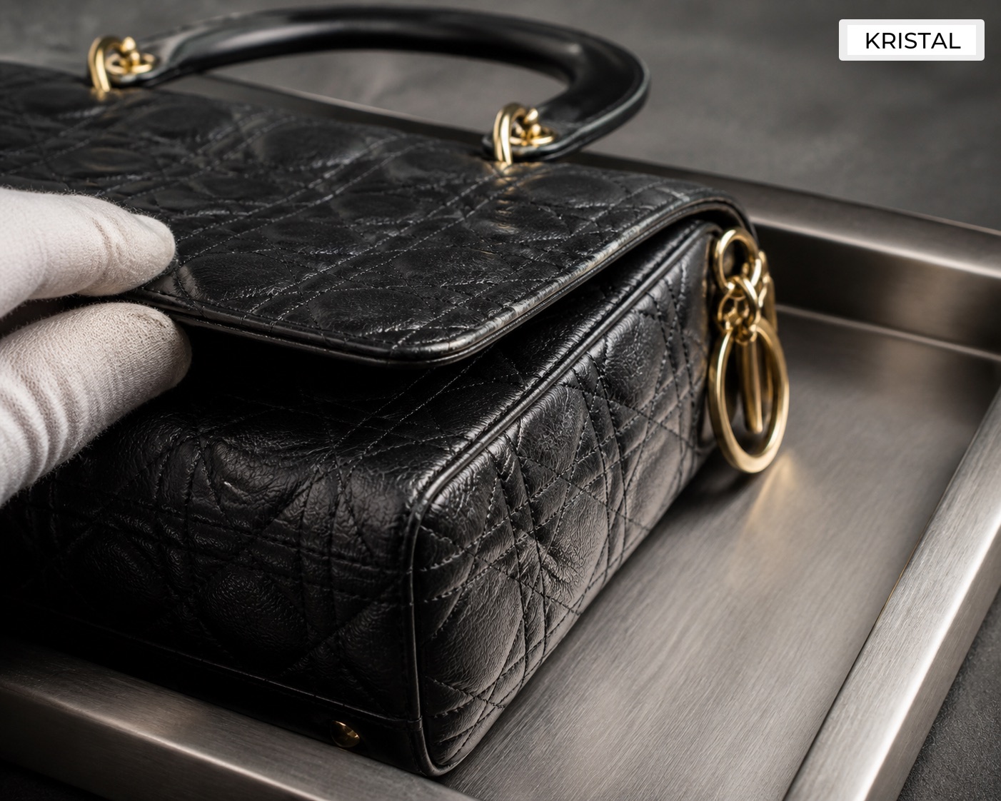 Editorial inline image showing close Dior-style valuation inspection of handles, flap edges, hardware, and corner wear in Malaysia