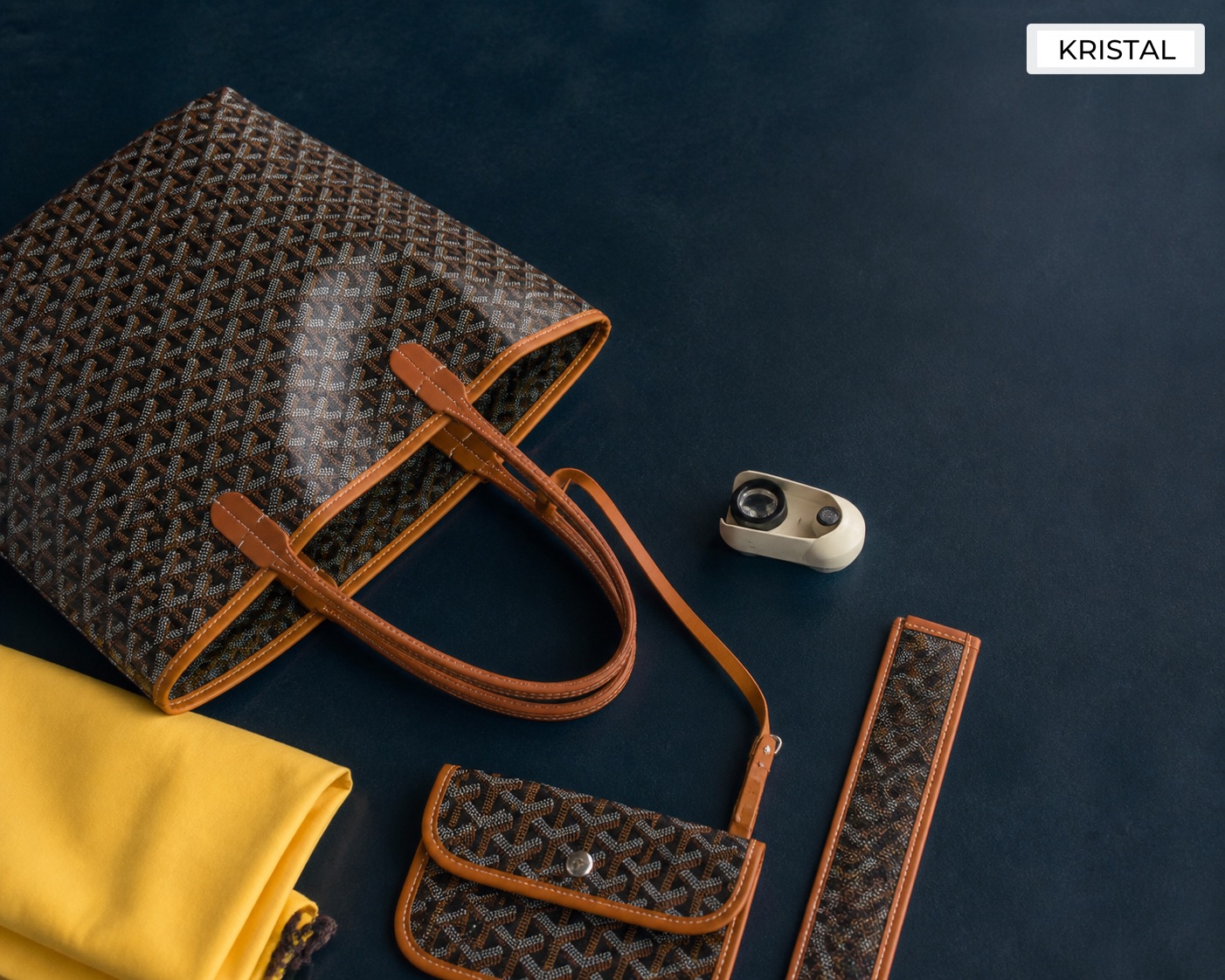 Editorial inline image showing a Goyard-style tote, detachable pouch, dust bag, and inspection tool arranged for valuation review in Malaysia