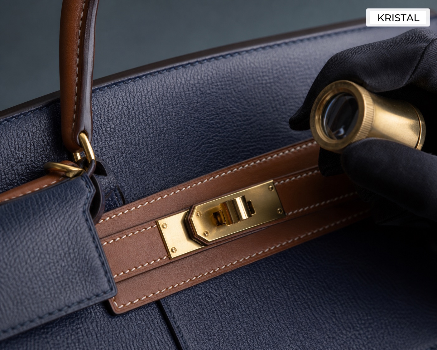 Editorial inline image showing close inspection of a Hermès-style top-handle bag's leather grain, hardware, and sangles during valuation review in Malaysia