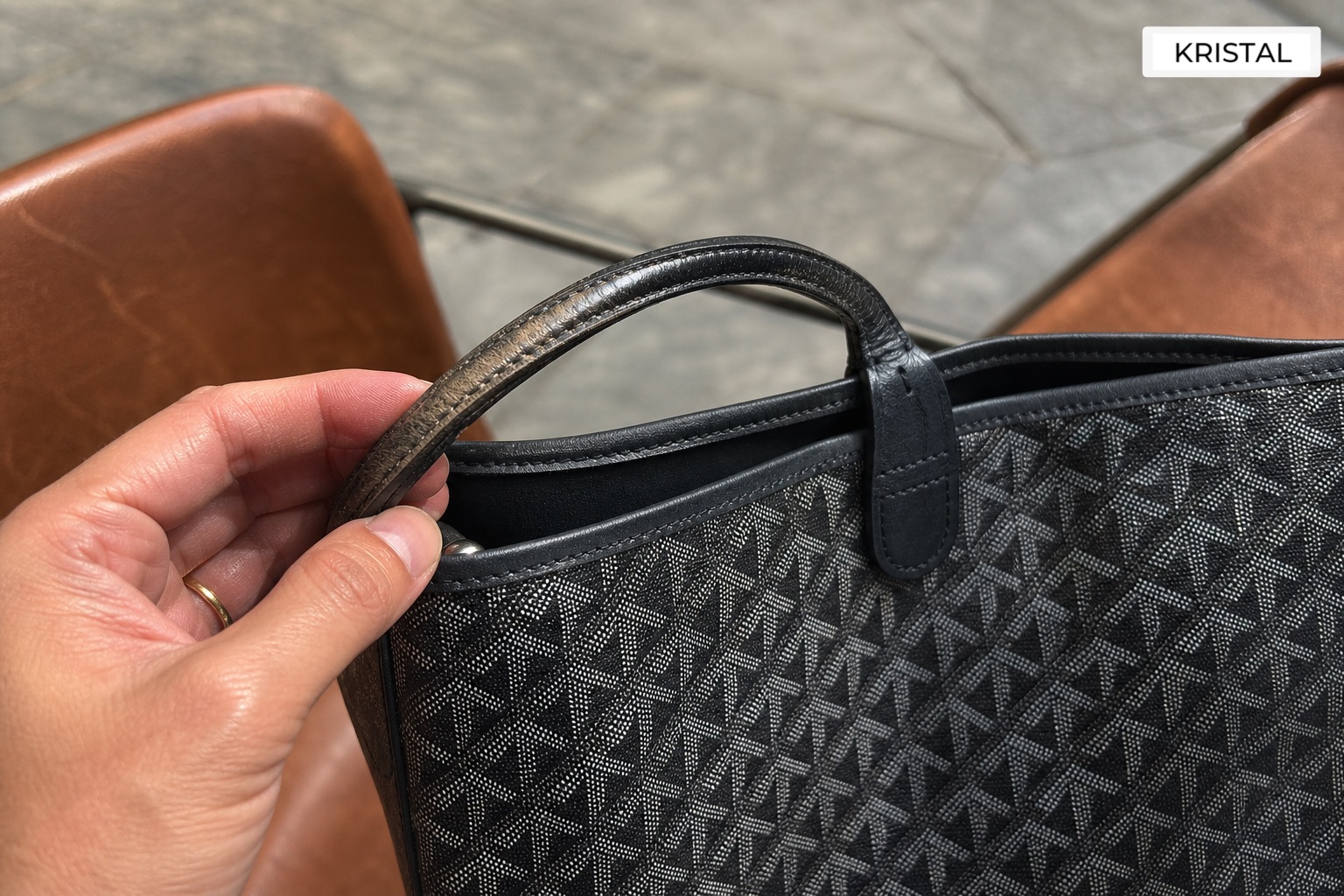 Close-up inspection of coated canvas handle wear and edge condition