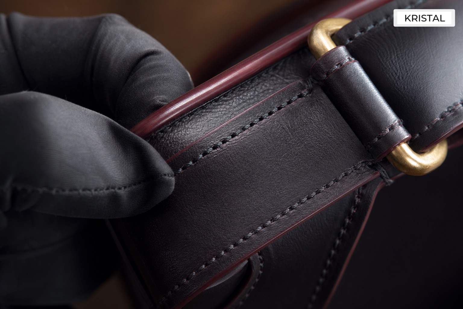 Close-up inspection of handbag stitching, edge paint and hardware before a sale