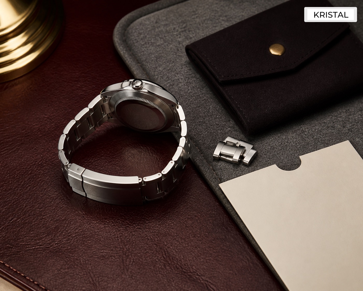 Editorial inline image showing a Rolex-style watch with box, papers, spare links, and service documents arranged for valuation review in Malaysia