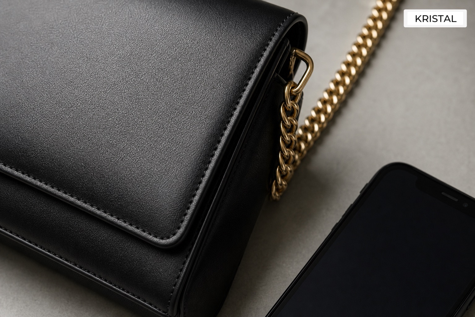 Close-up of minimalist luxury shoulder bag leather, hardware and corners during resale assessment