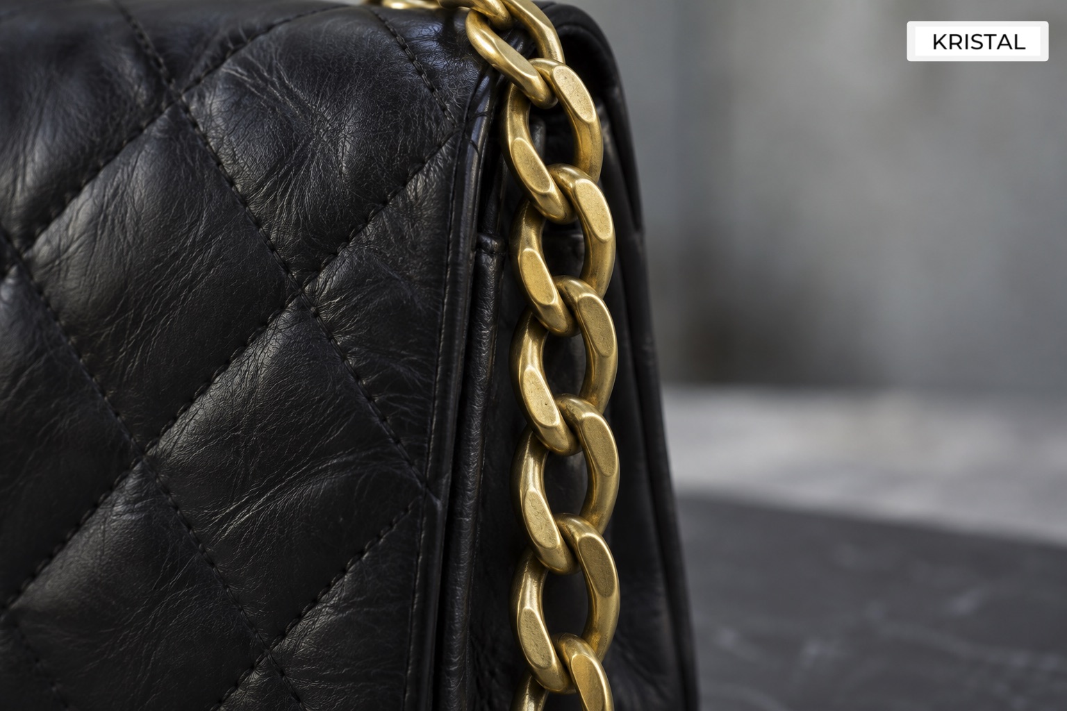 Illustrative all-metal flat chain beside a quilted leather edge