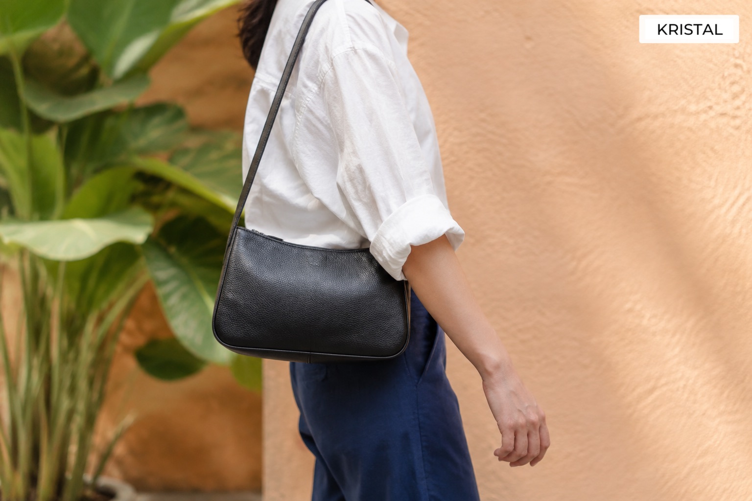 A shoulder bag resting at hip height during an everyday walk