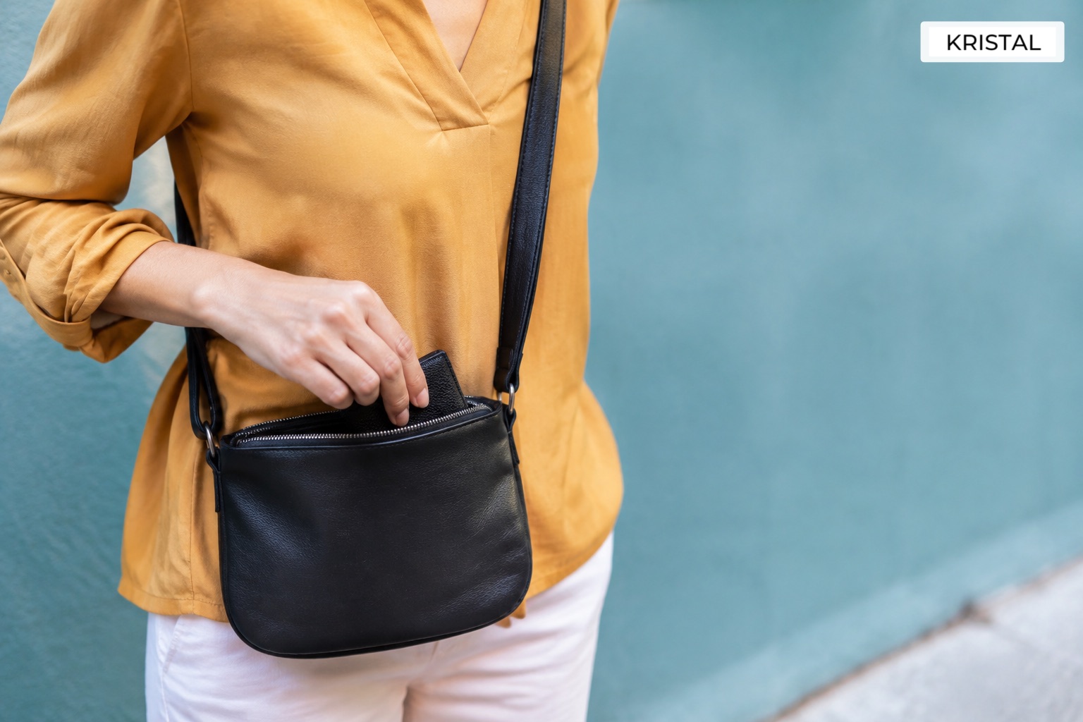 Reaching for a small wallet while carrying a shoulder bag