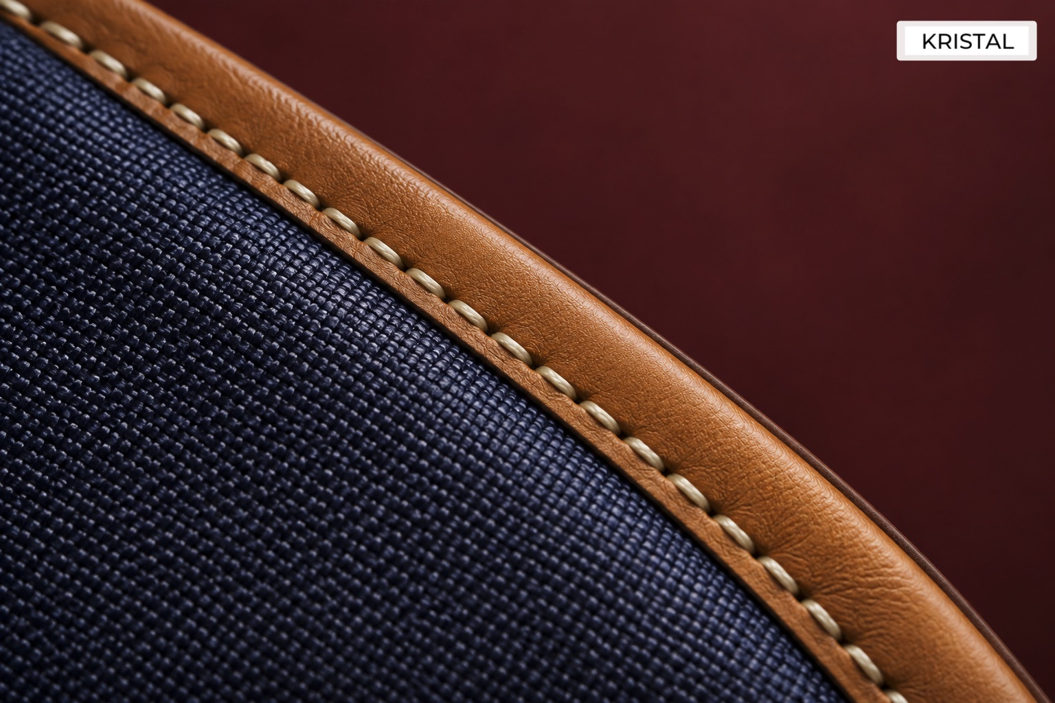 Illustrative textile sample joined to a leather trim with a stitched seam